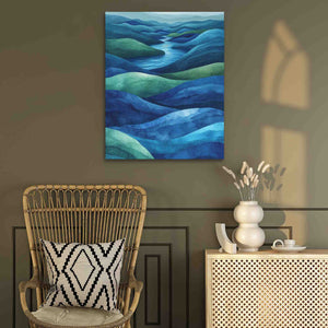 a room with a wicker chair and a painting on the wall