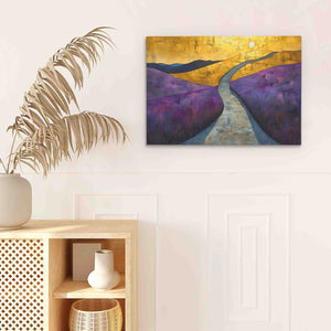 a painting hanging on a wall above a plant