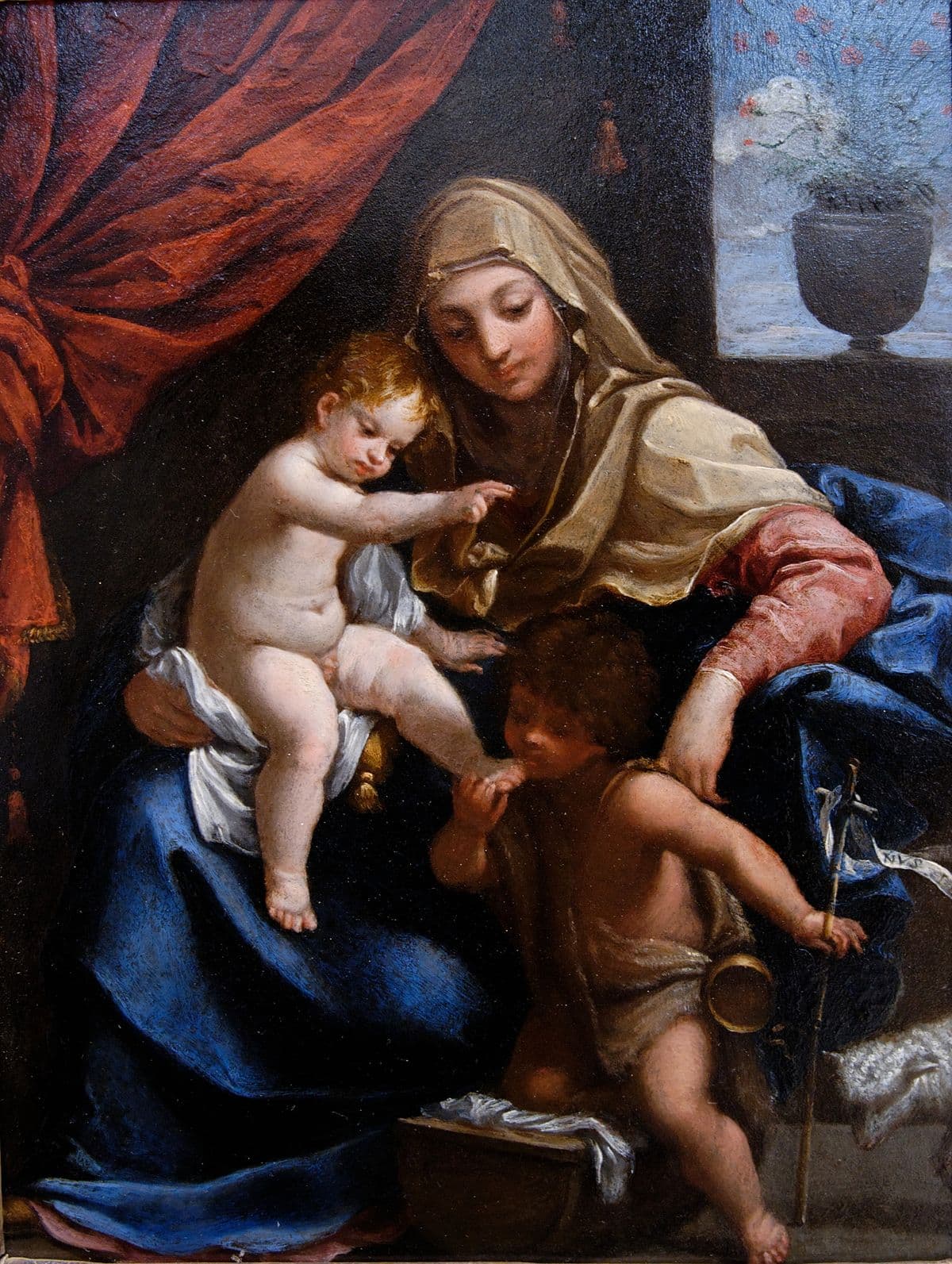 Madonna with Child and St. John the Baptist by Guido Reni (1628), oil on canvas at Louvre, Paris