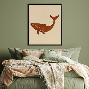 a picture of a whale on a wall above a bed