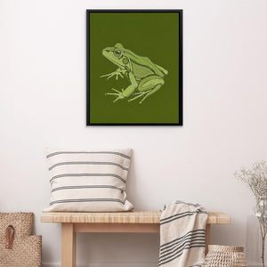 a green frog sitting on top of a wooden bench