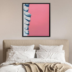 a bed with a pink and blue painting above it