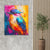 a painting of a colorful bird on a wall next to a potted plant