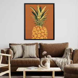 a living room with a brown couch and a pineapple painting on the wall