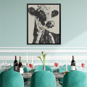 a picture of a cow is hanging above a dining room table