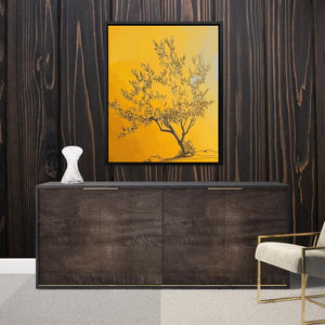 a picture of a tree on a wall above a cabinet