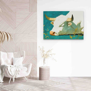 a painting of a cow is hanging on a wall