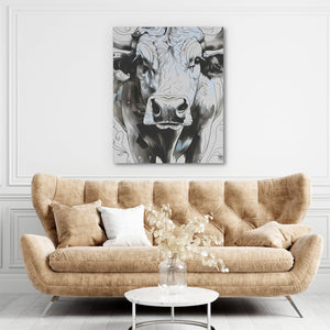 a living room with a couch and a cow painting on the wall