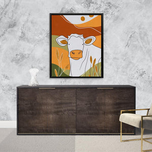 a picture of a cow is hanging on a wall