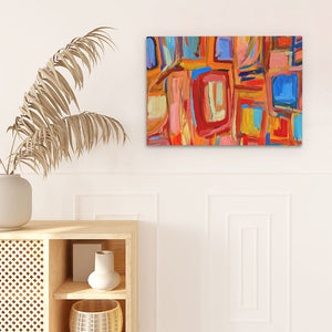 a painting hanging on a wall next to a potted plant