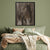 a bed with a green comforter and a painting on the wall