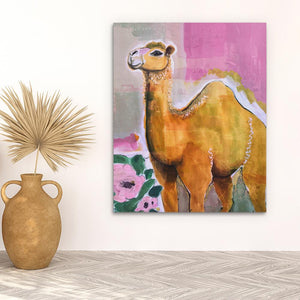 a painting of a camel on a wall next to a potted plant