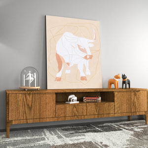 a picture of a bull on a wall above a dresser