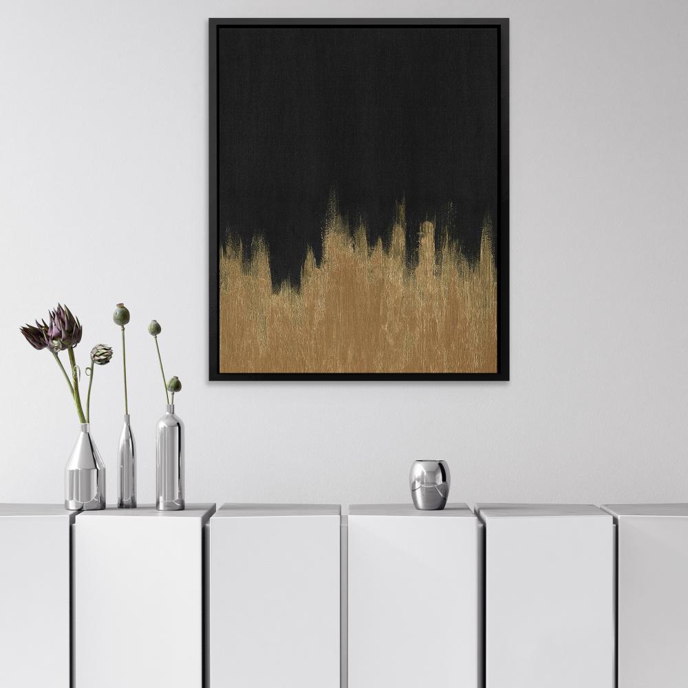 a black and gold painting on a white wall