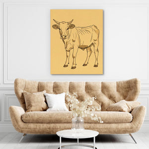 a living room with a couch and a cow on the wall