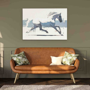 a painting of a running horse hangs above a couch