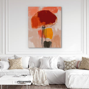 a living room with a white couch and a painting on the wall