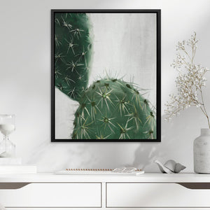 a picture of a cactus in a frame on a wall