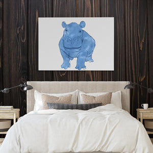 a picture of a rhinoceros on a wall above a bed