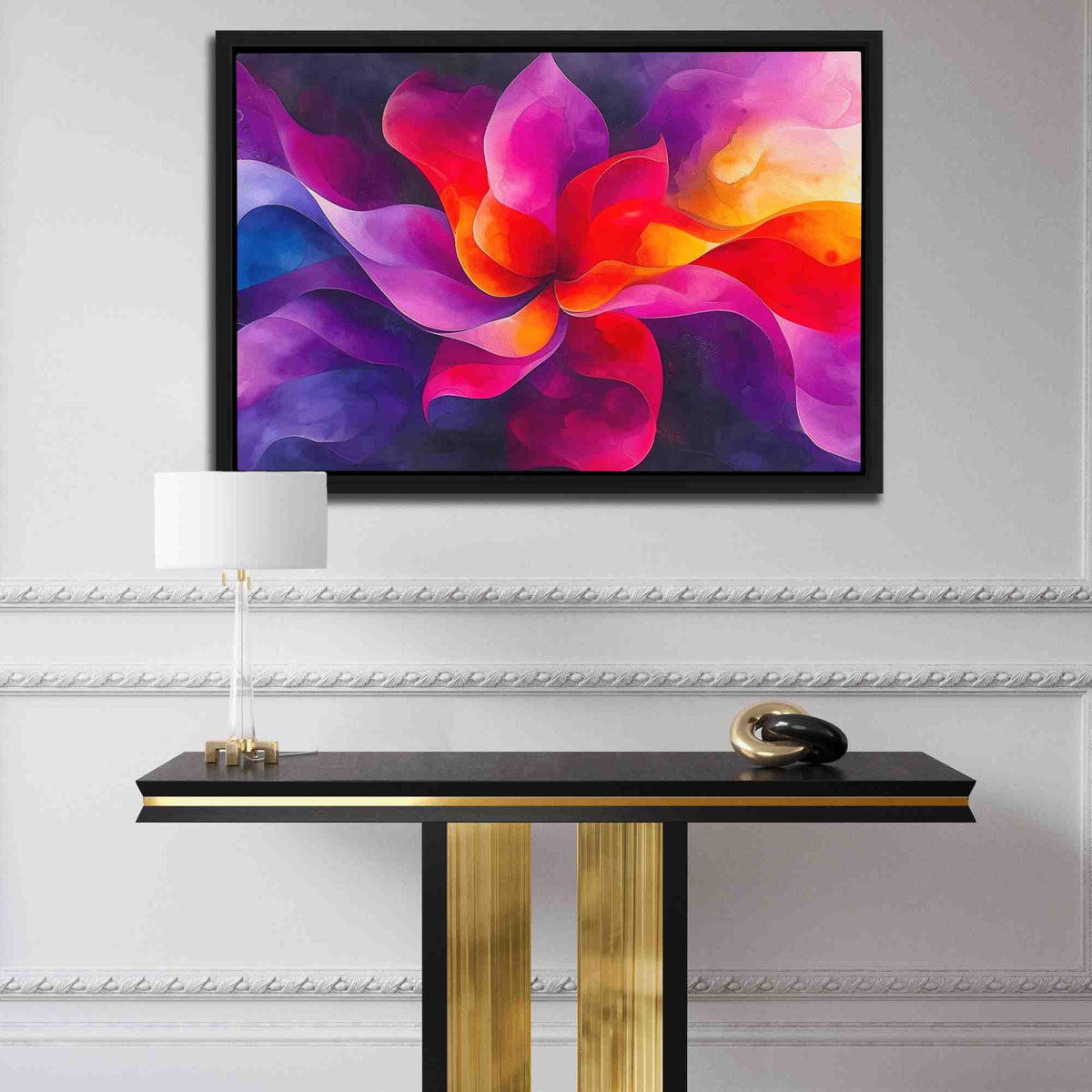 a table with a lamp and a painting on the wall