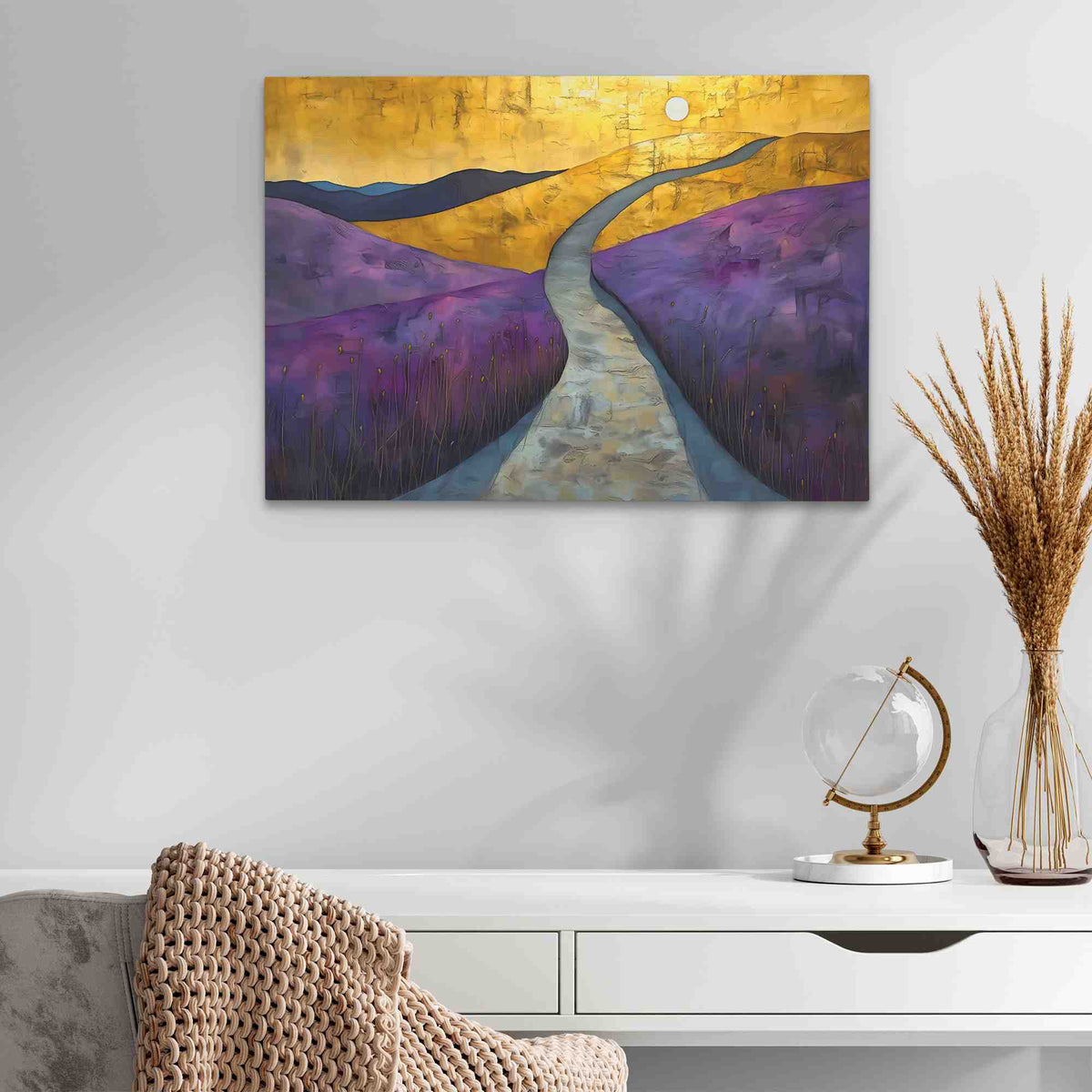 a painting on a wall above a white table