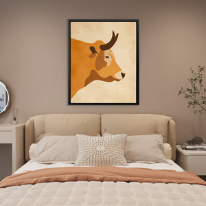 a picture of a cow on a wall above a bed