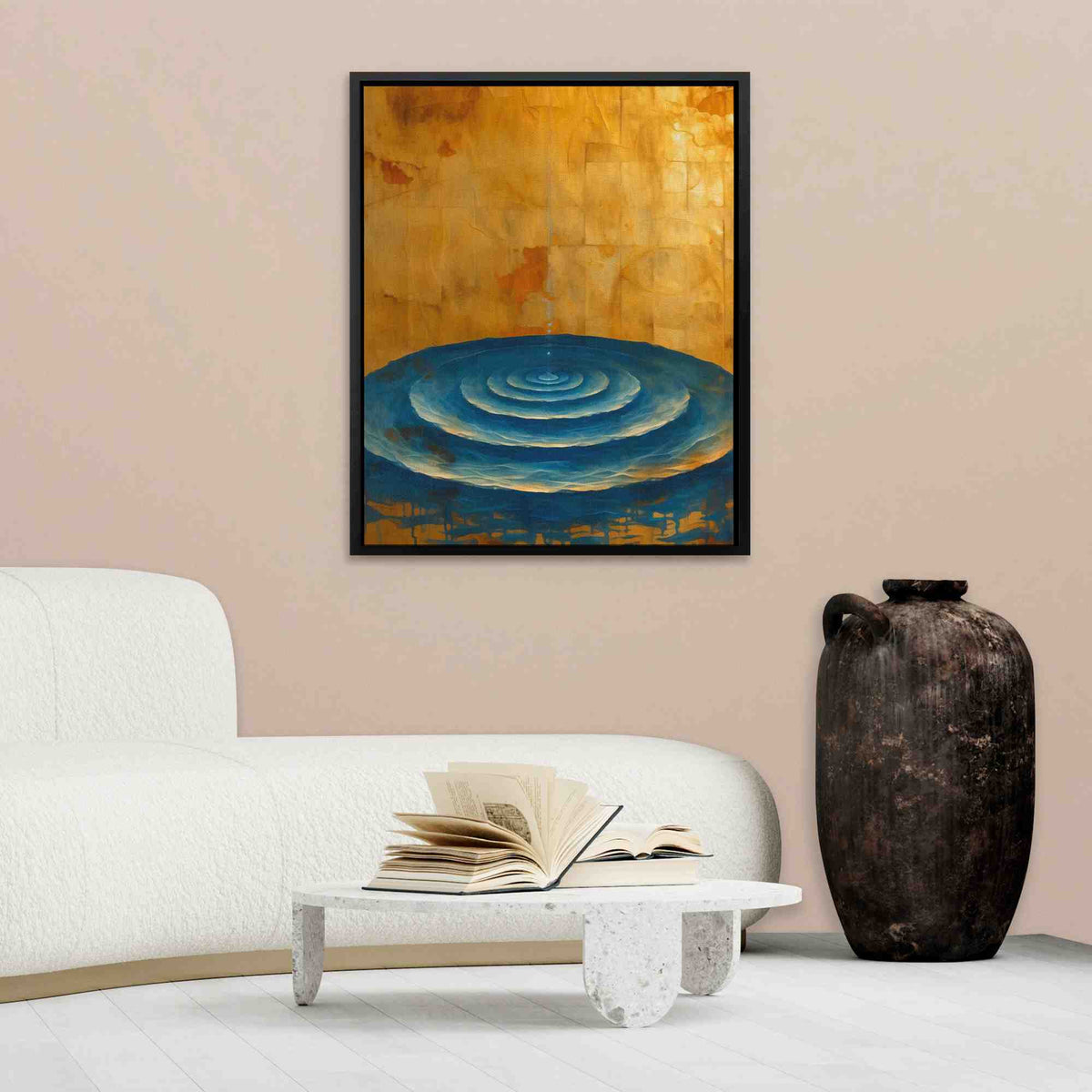 a living room with a white couch and a painting on the wall