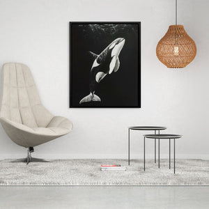 a black and white photo of a whale in the water