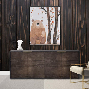 a picture of a bear in a forest hangs on a wall