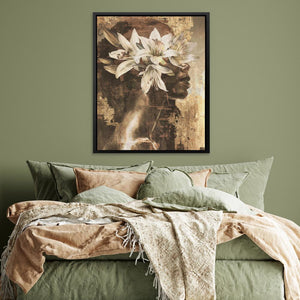 a bed with a green comforter and a painting on the wall