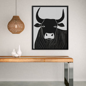 a picture of a cow on a wall above a table