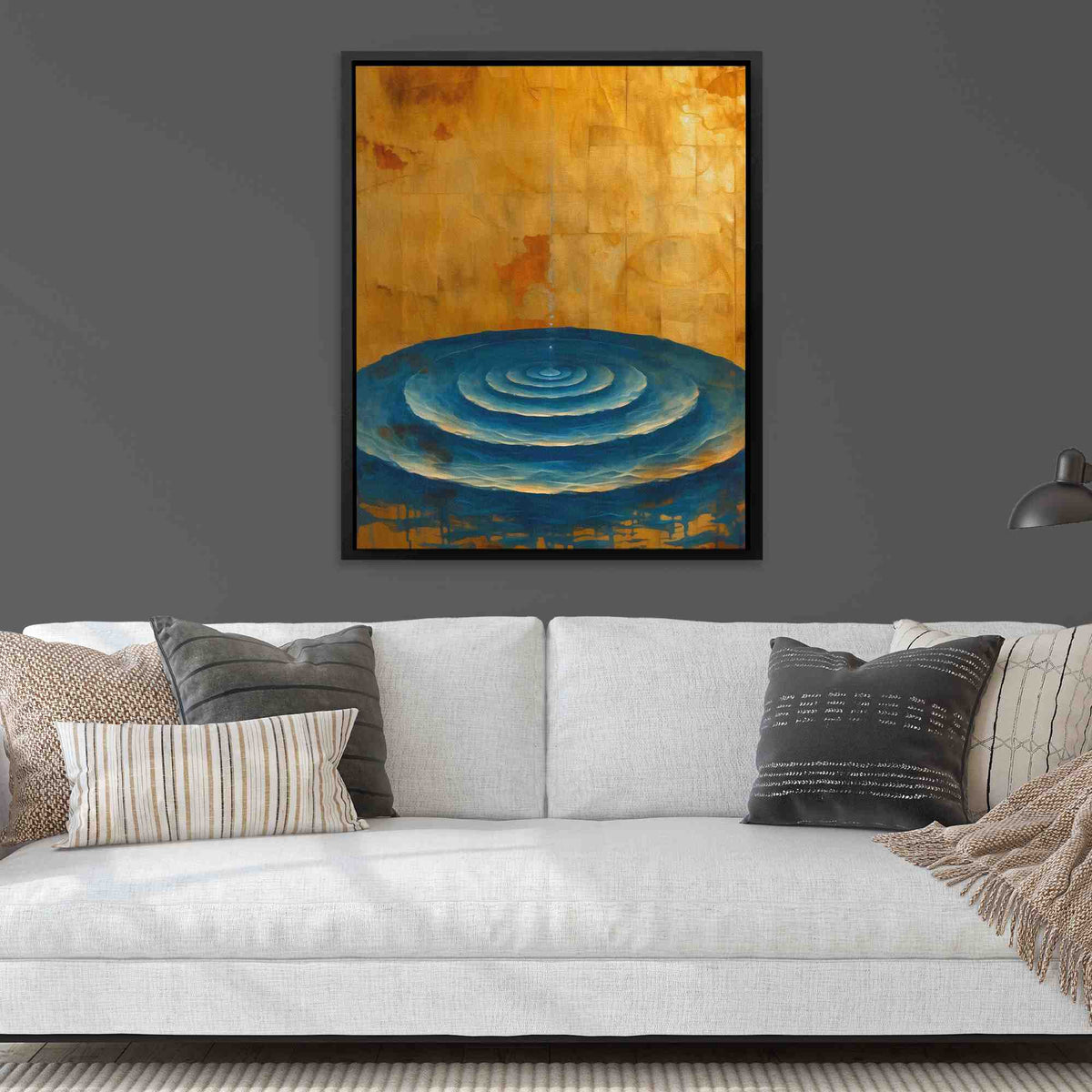 a living room with a couch and a painting on the wall