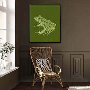 a green frog sitting on top of a chair next to a window