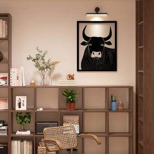 a room with a book shelf and a cow picture on the wall