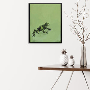 a picture of a frog on a wall above a table