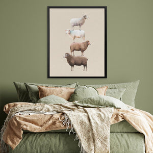 three sheep are standing on top of each other on a bed