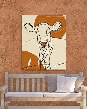 a painting of a cow on a wall above a bench