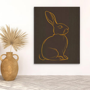 a picture of a rabbit on a wall next to a potted plant