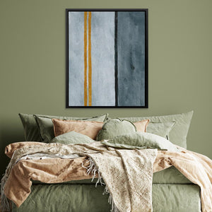 a bed with a green comforter and a painting on the wall