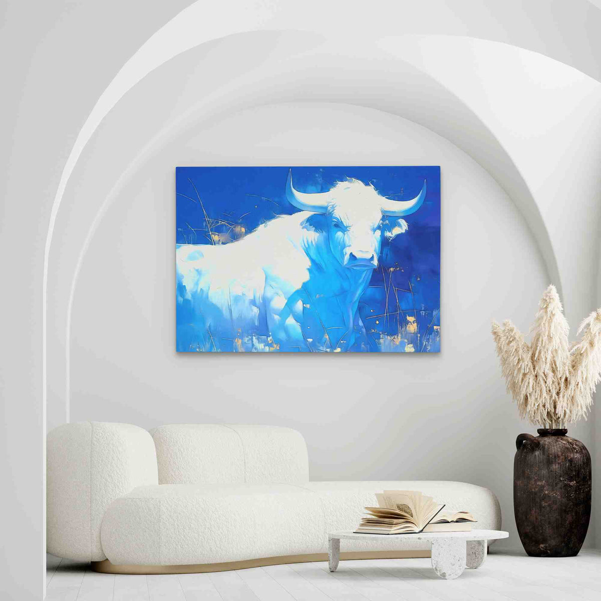 a living room with a white couch and a painting on the wall