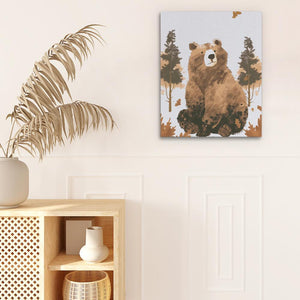 a picture of a bear on a wall next to a potted plant