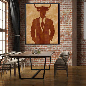 a picture of a bull in a suit hangs on a brick wall