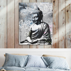 a painting of a buddha statue on a wall above a bed