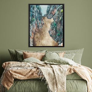 a bed with a green comforter and a painting on the wall