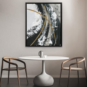 a table with two chairs and a painting on the wall