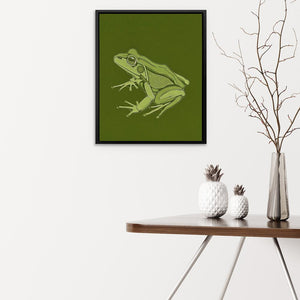 a green frog sitting on top of a wooden table