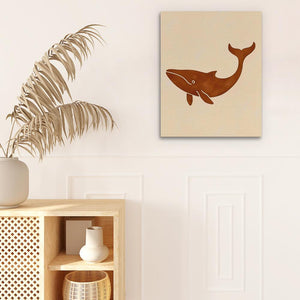 a painting of a whale on a wall next to a potted plant