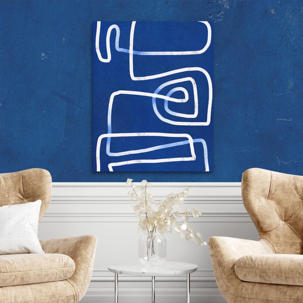 a blue and white abstract painting on a wall