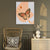 a painting of a butterfly on a wall next to a chair