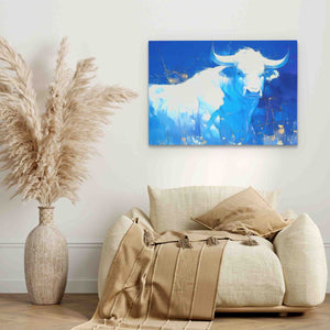 a living room with a cow painting on the wall